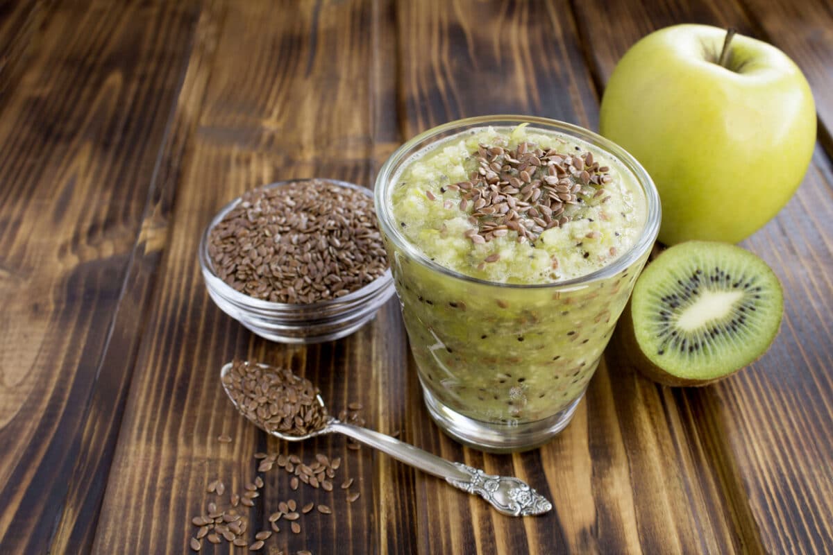Smoothie with flax seeds, kiwi and green apple in the drinking glass