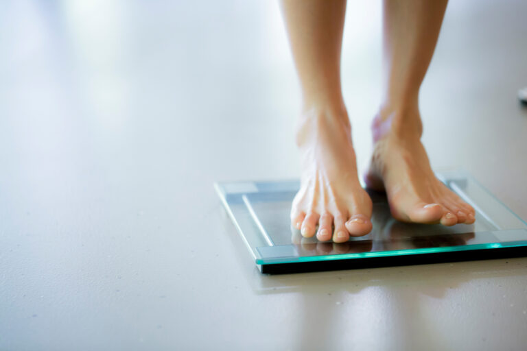 Healthy body fat percentage woman on scale