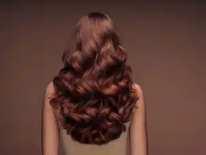 Brazilian blowout vs karatin - woman with long curly hair, rear view