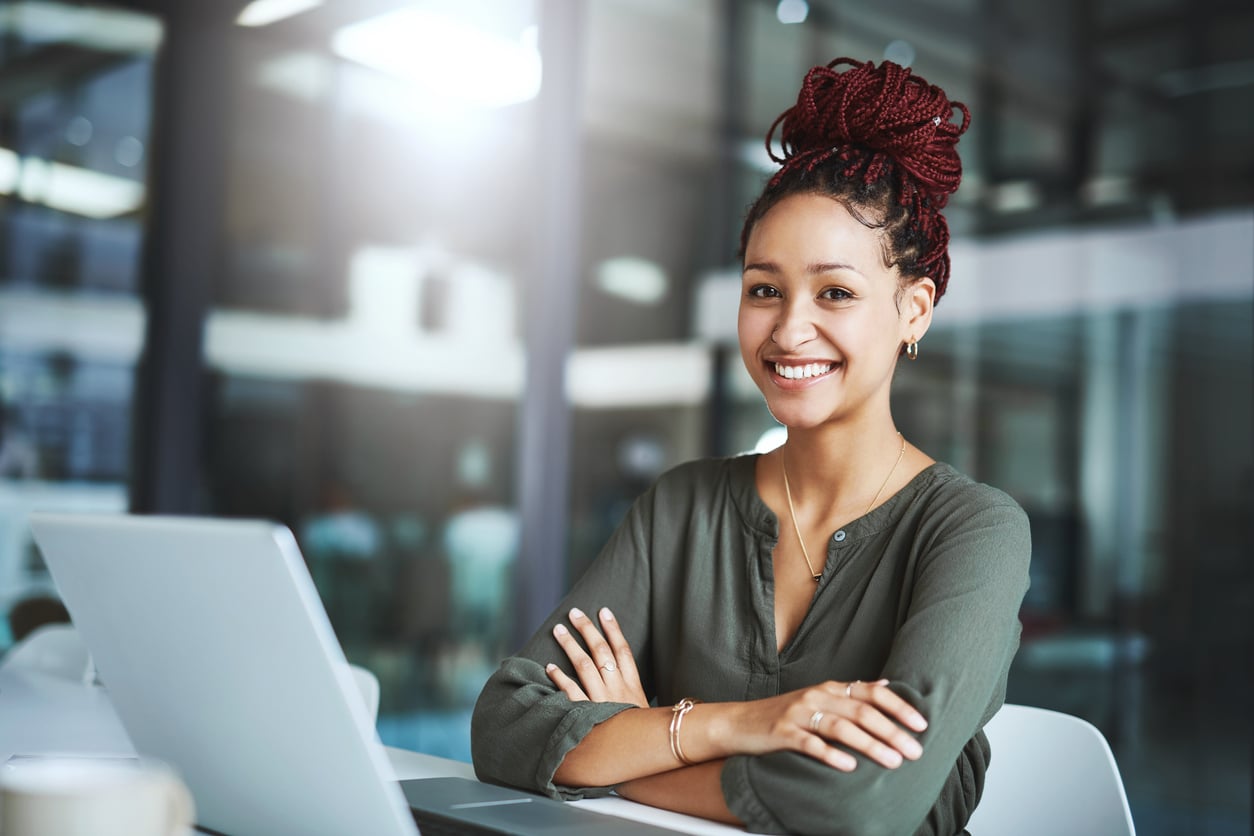 African American woman with burgundy/maroon hair in an office
