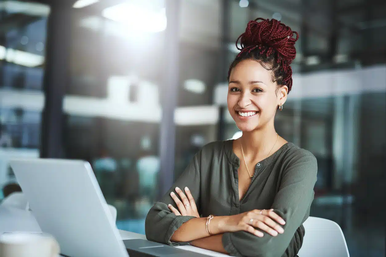 African American woman with burgundy/maroon hair in an office