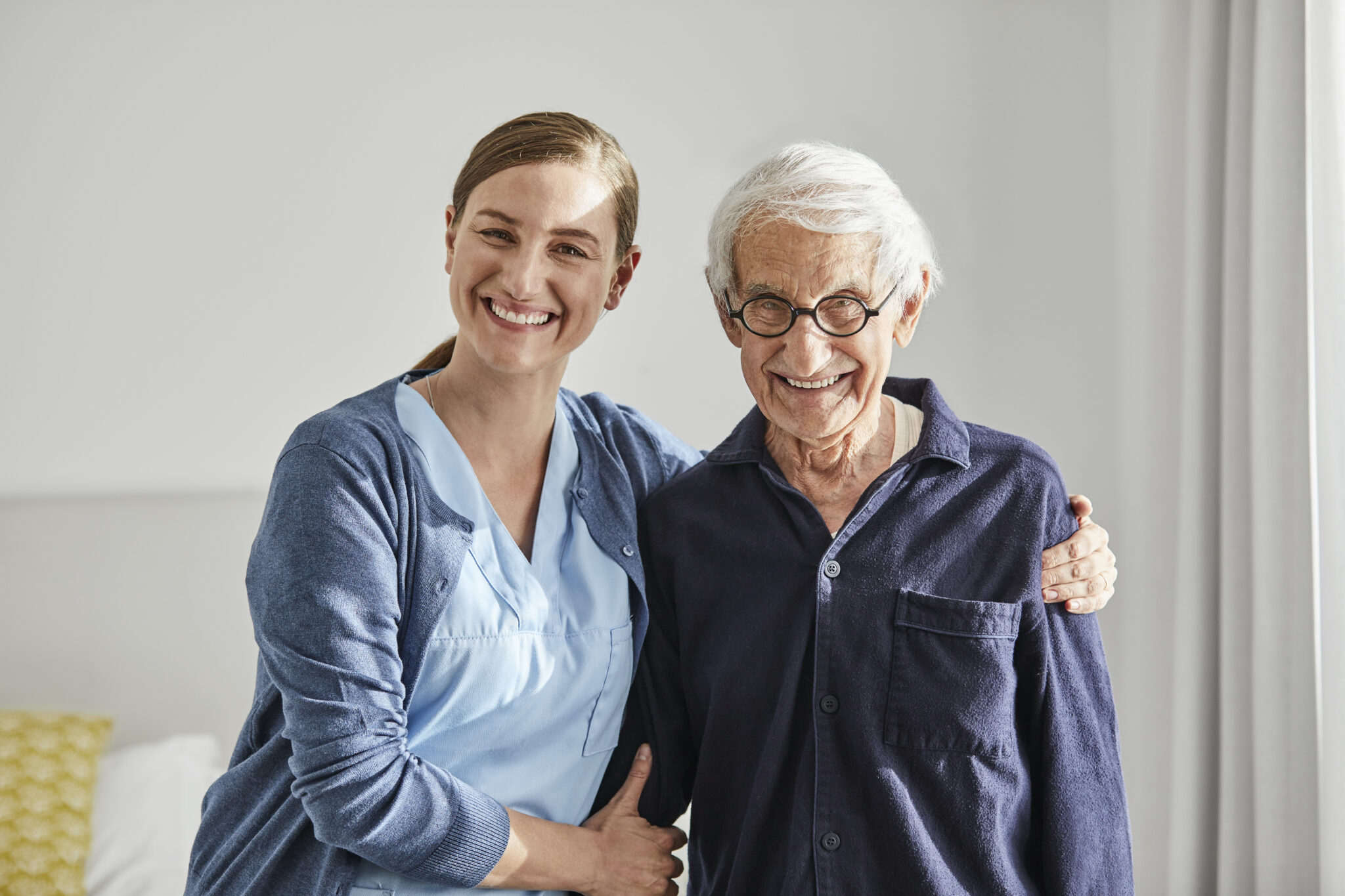 Happy senior male with female caregiver care.com