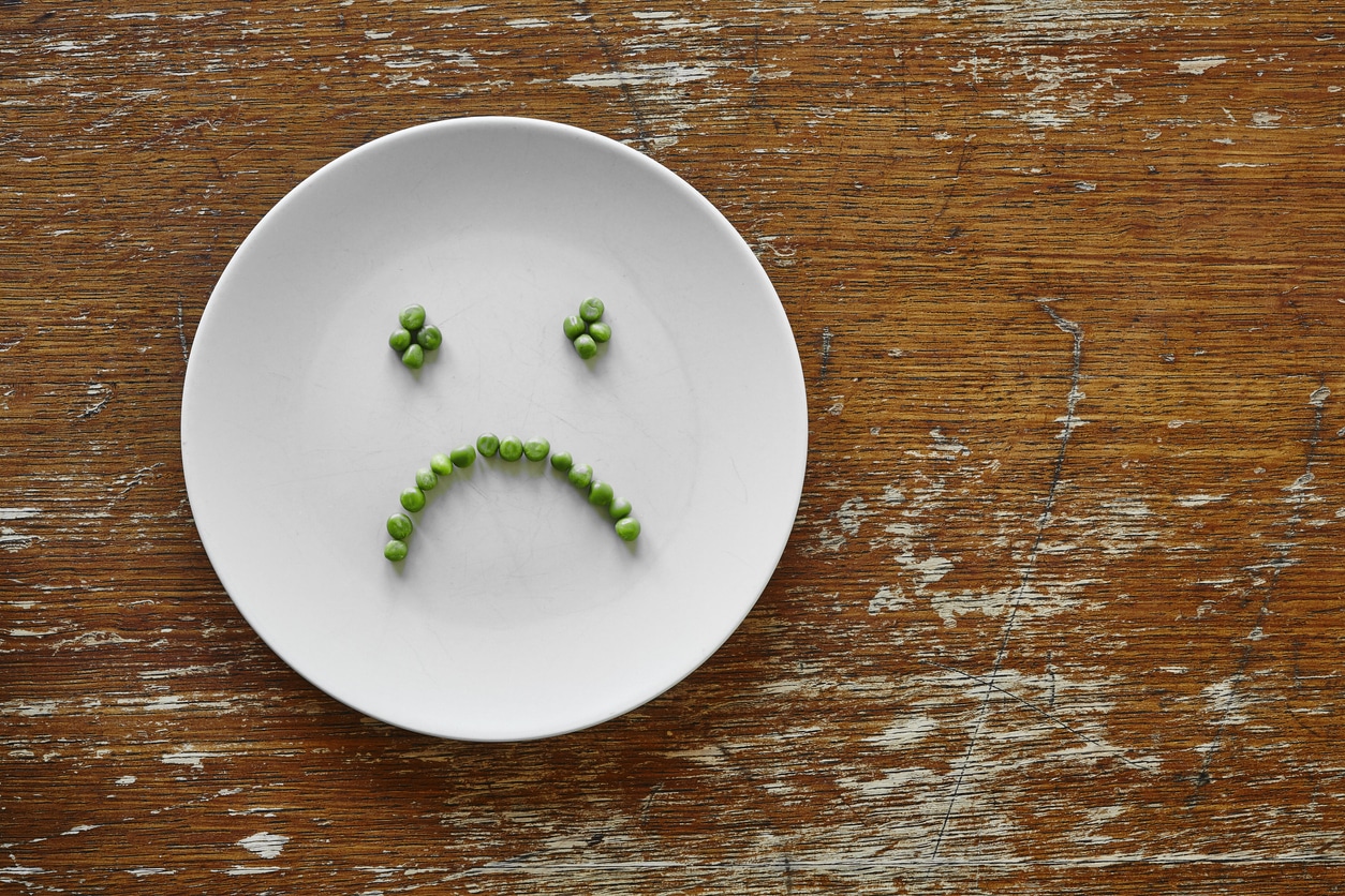 Peas on a plate in a sad face