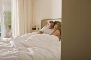 Couple laying in bed - Perimenopause sex drive