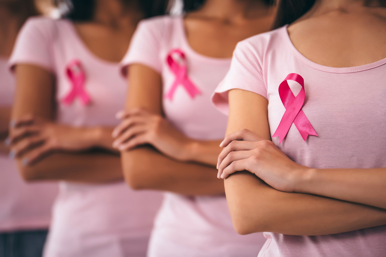 women wearing pink ribbons in honor of Breast cancer awareness -