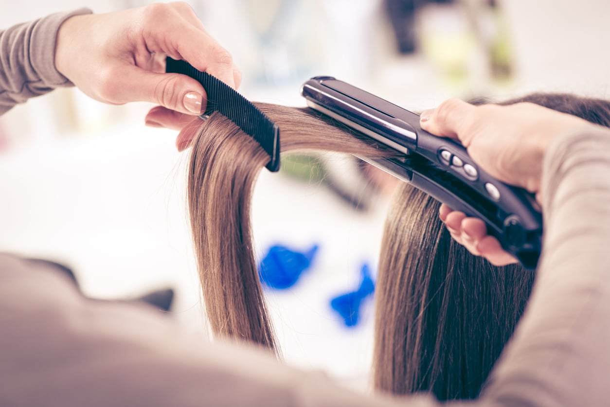 Stylist using a flat iron 