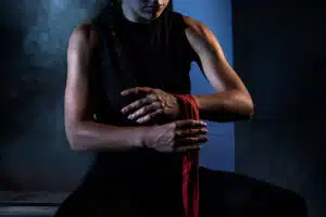 Muay Thai - Woman putting wraps on her hands before a workout