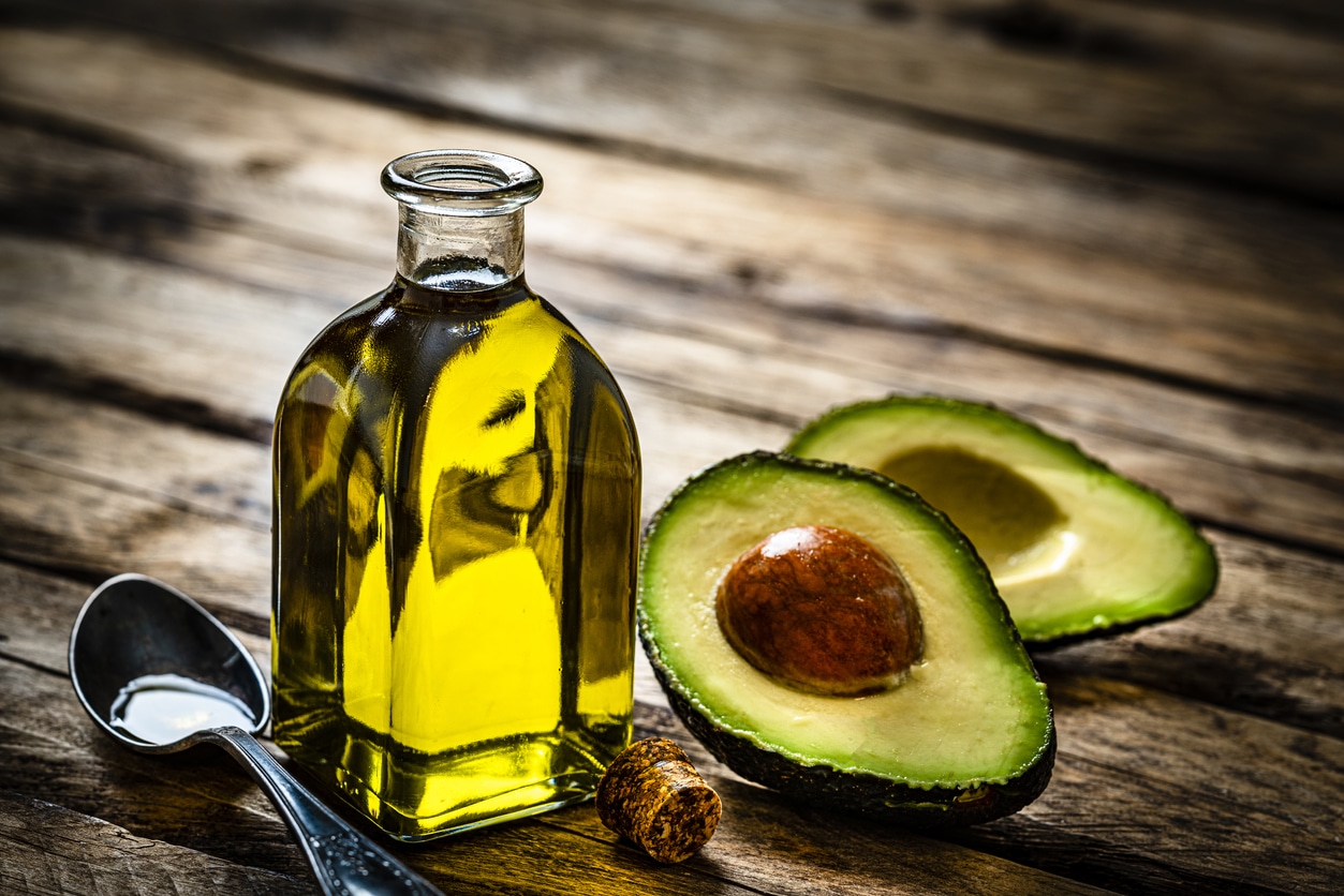 Avocado oil on rustic wooden table