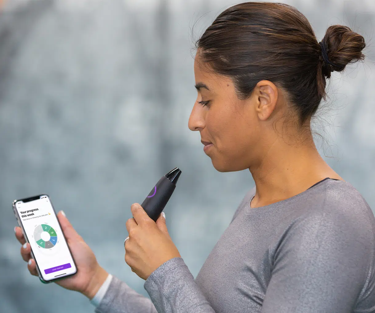 Girl holding Lumen Metabolism tracker looking at app