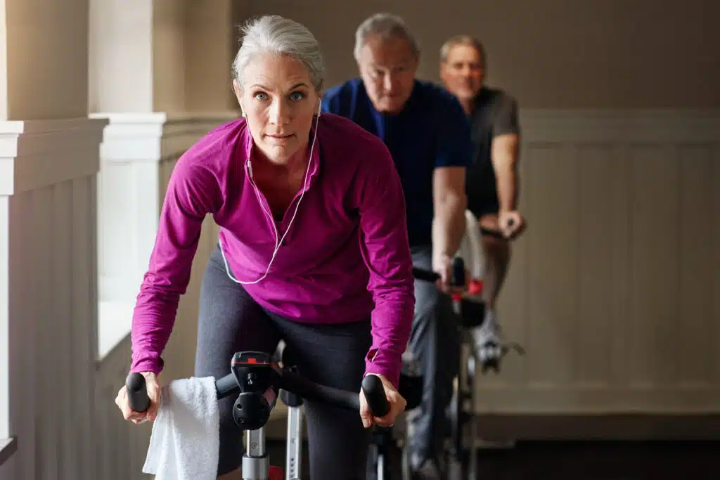 Winter workout routine - woman riding an exercise bike