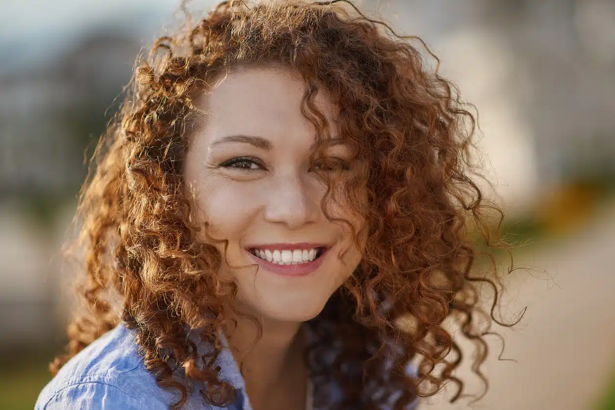 Shoulder length haircut with a deep part for women with curly hair