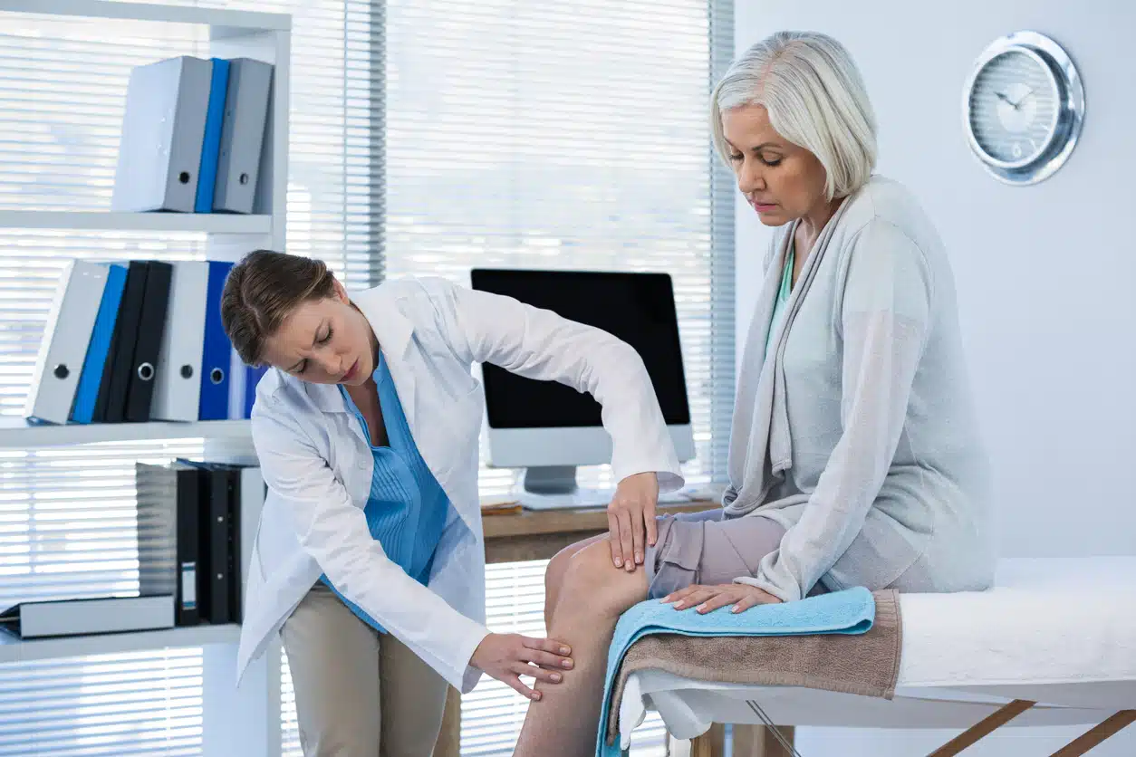 Doctor looking at patient's knee 