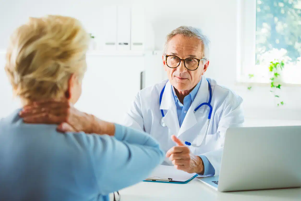 Woman talking to doctor about back pain