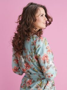 Woman with long brown curly hair