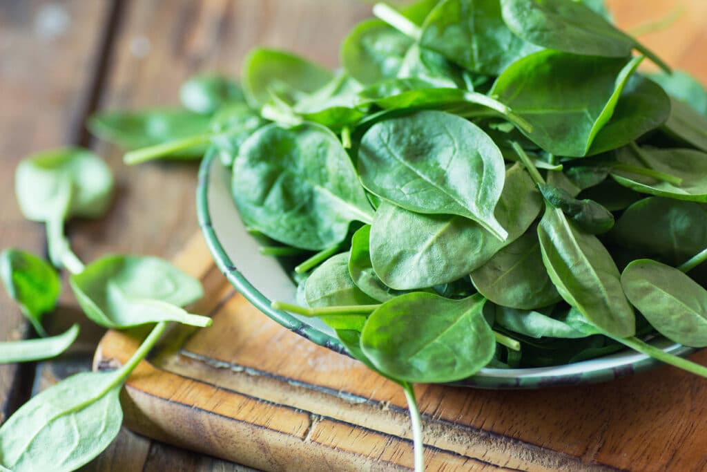 Spinach on a plate; foods that fight hair loss