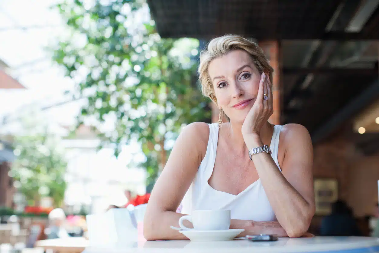 Woman dining alone at a sidewalk cafe