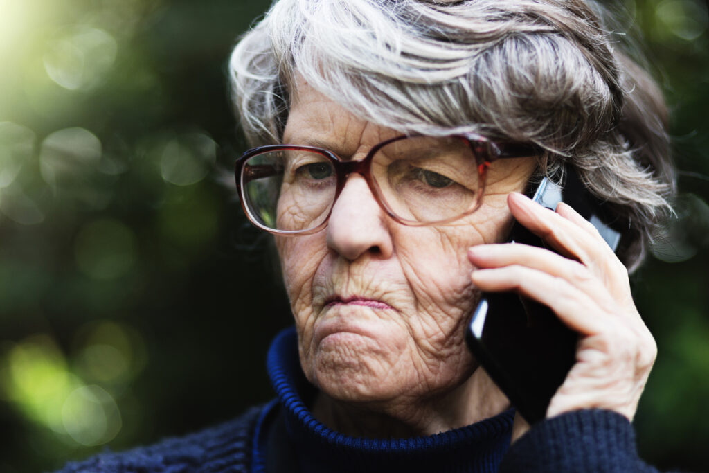 Negative elderly parent or Woman having an angry conversation on the phone