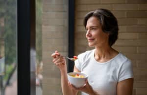 Woman eating a healthy breakfast or secret to getting lean and having more energy