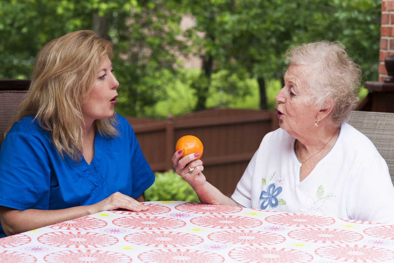 Patient working with speech therapist for apraxia or aphasia treatment