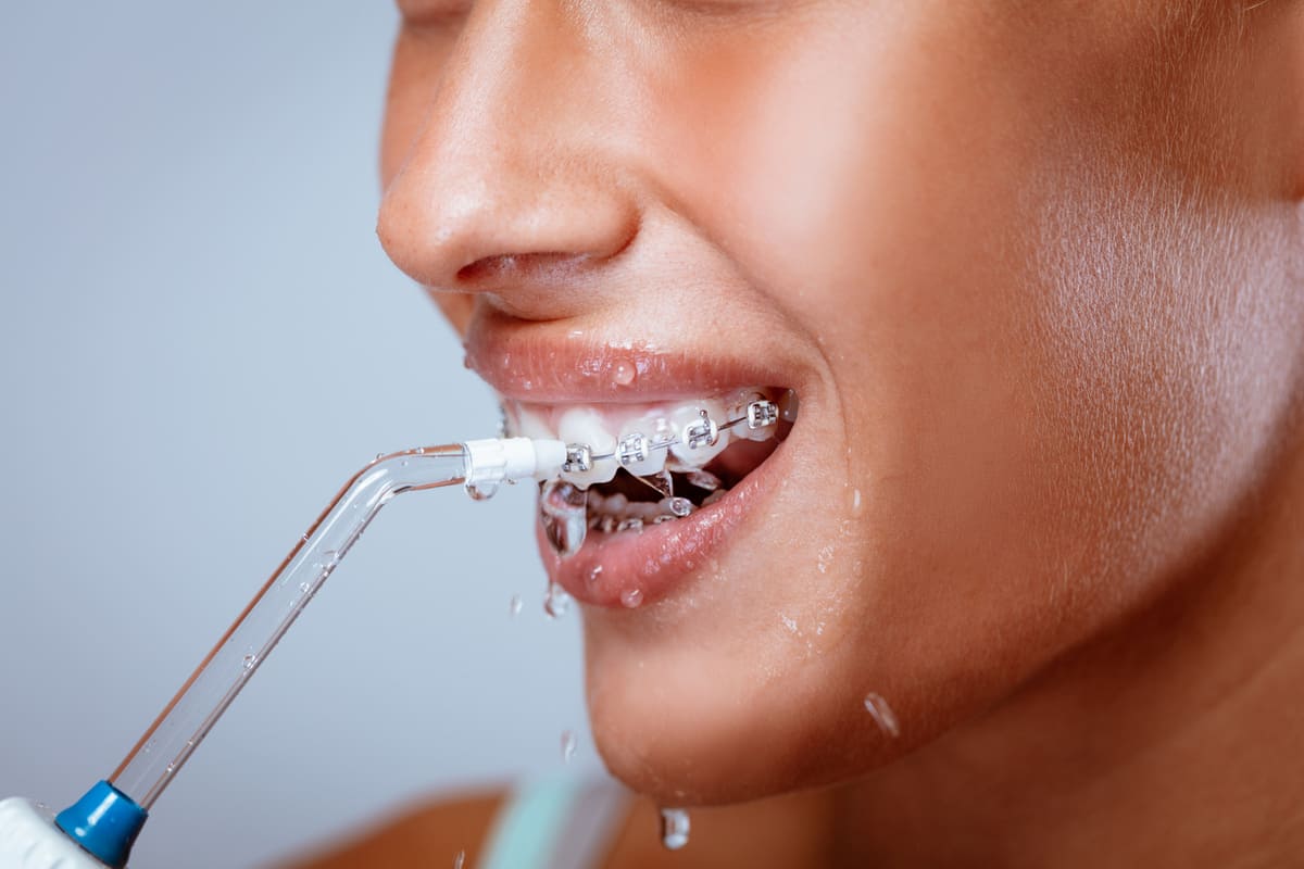 Cleaning teeth with water pic