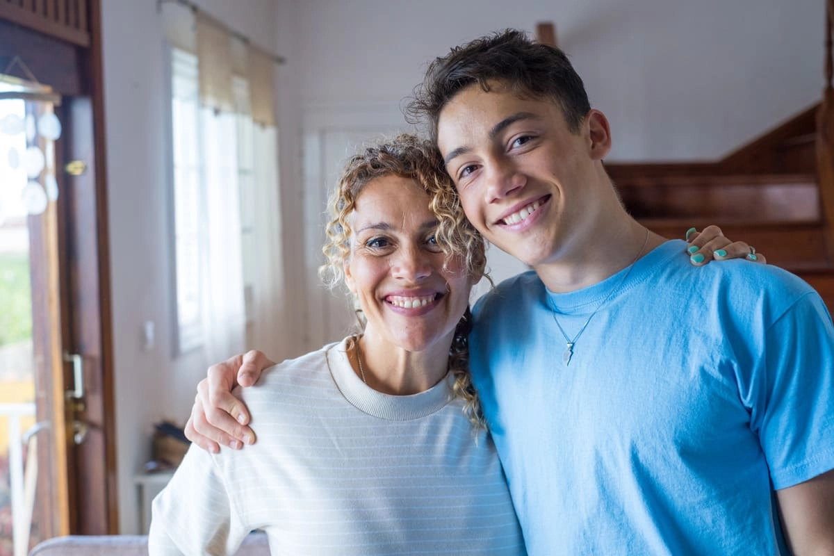 Mom hugging teen son