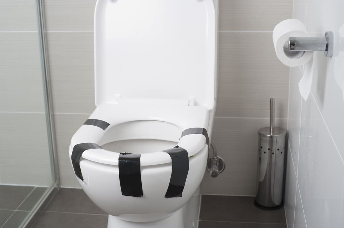 Toilet seat taped down
