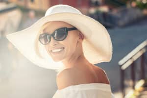 Woman wearing trendy sunglasses and a sunhat