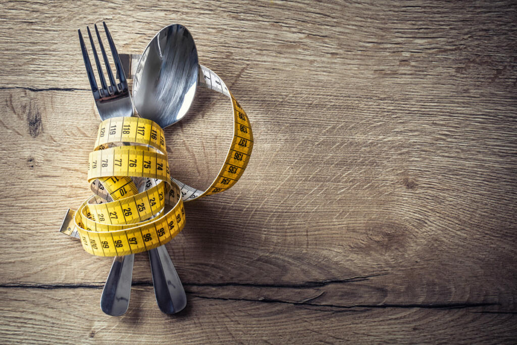 Diet image with fork and spoon and measuring tape