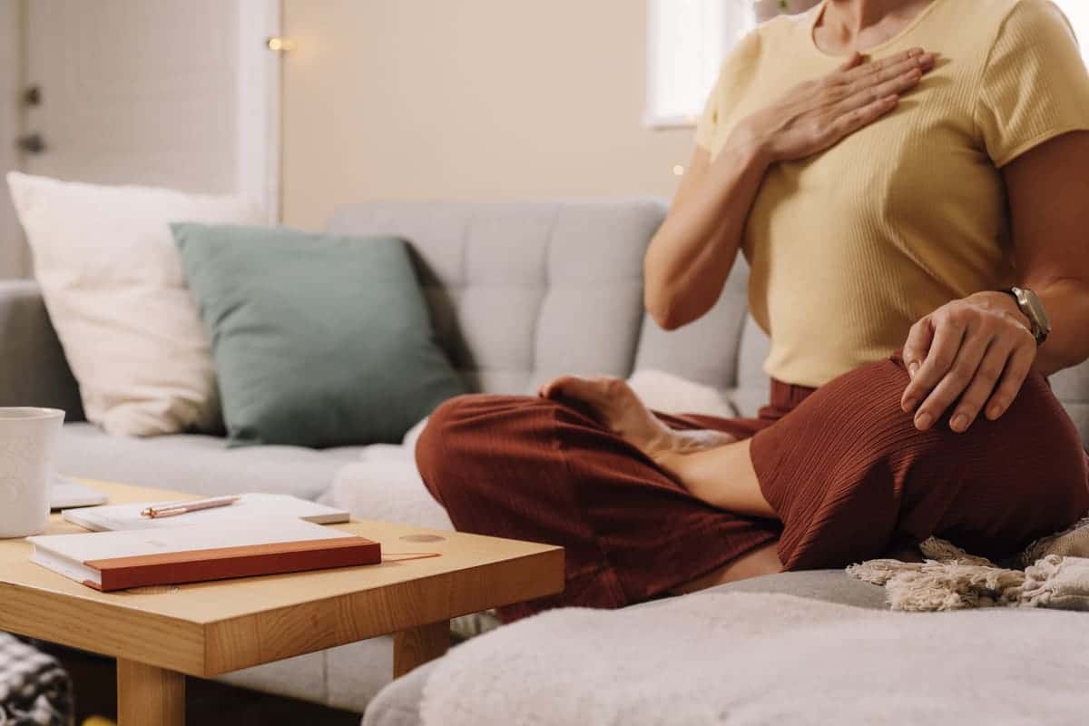 Mindful breathing woman on couch
