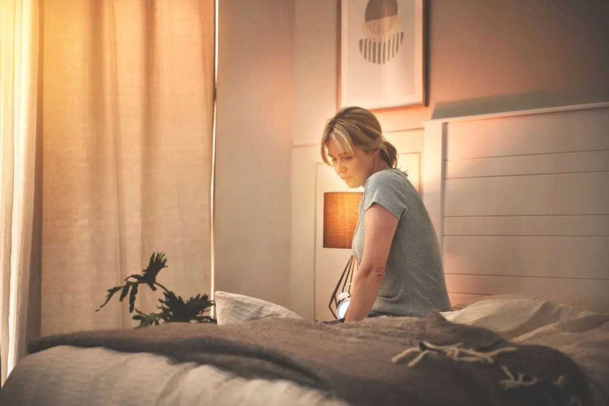PMDD can cause depression, sad woman in bed
