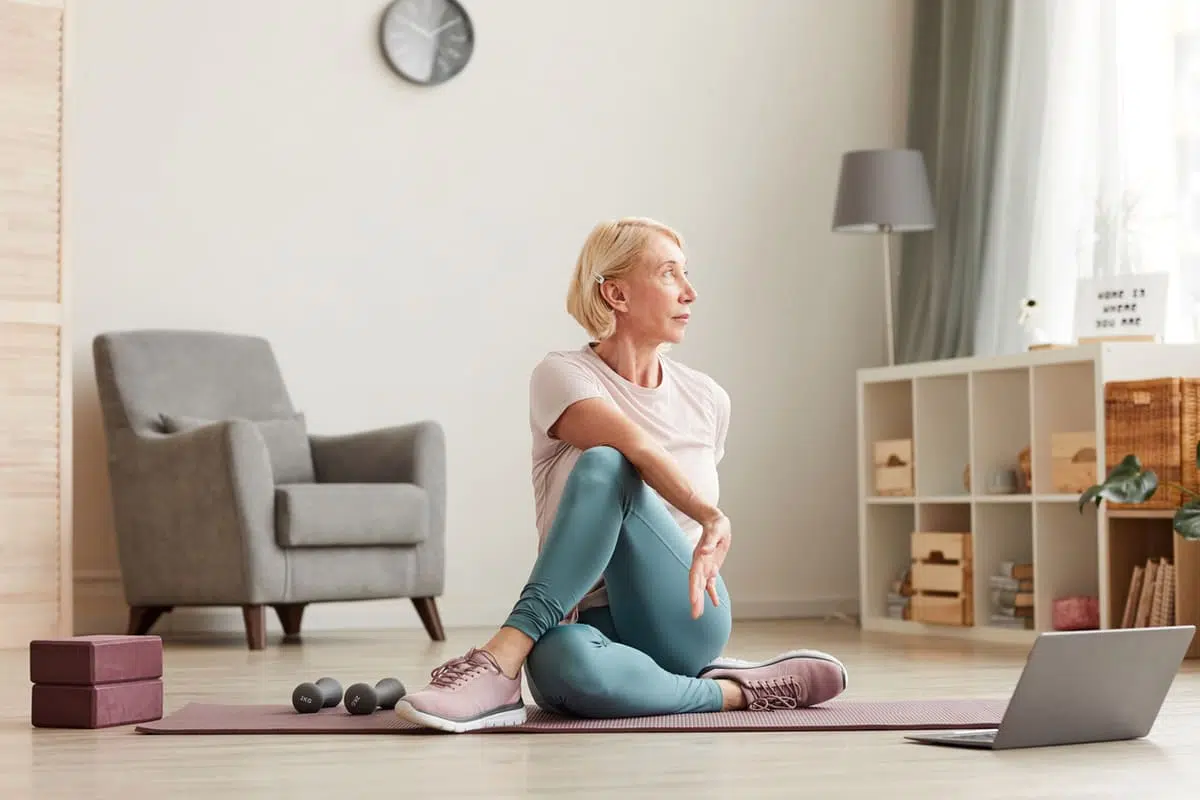 Woman stretching and watching a video