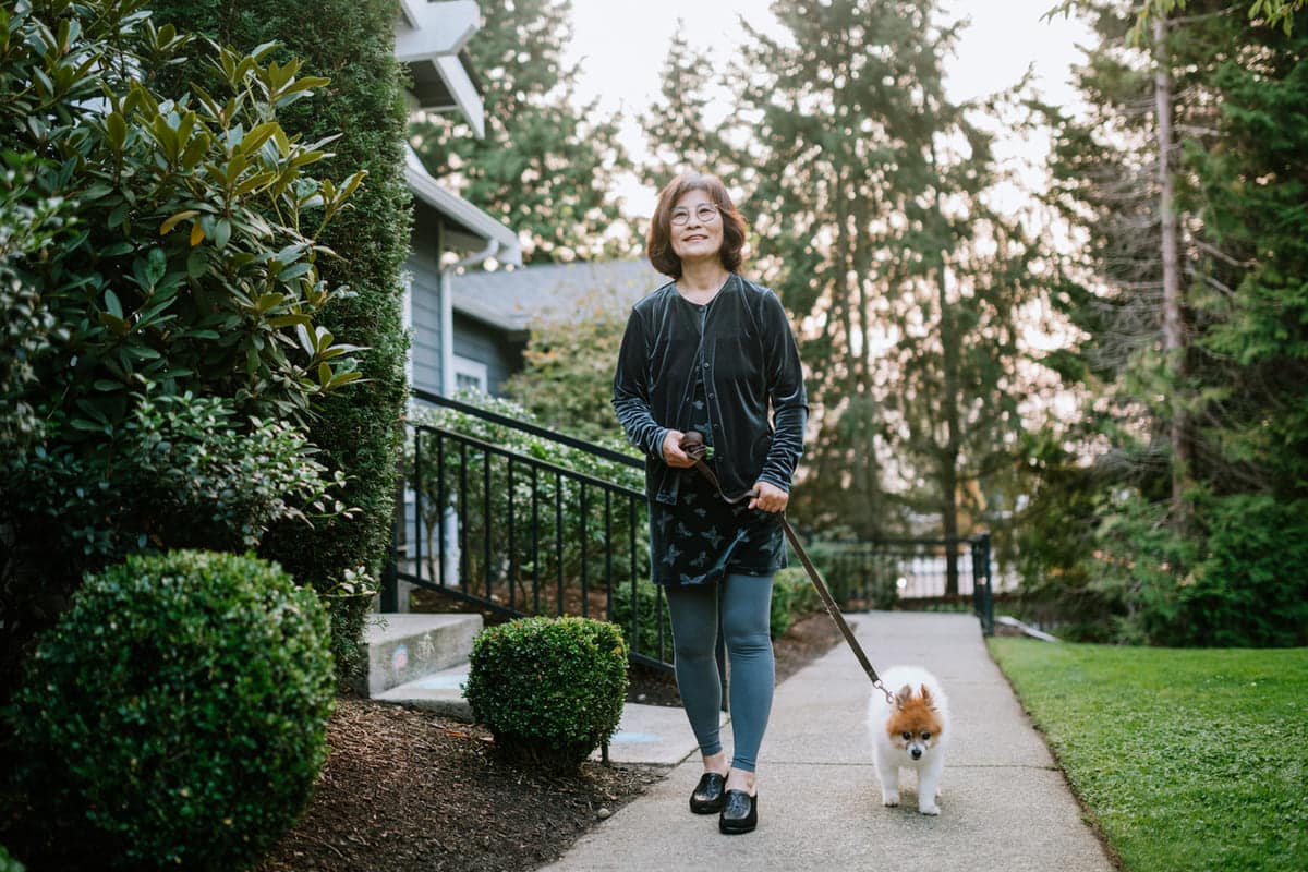 woman exercising out on a walk with her dog