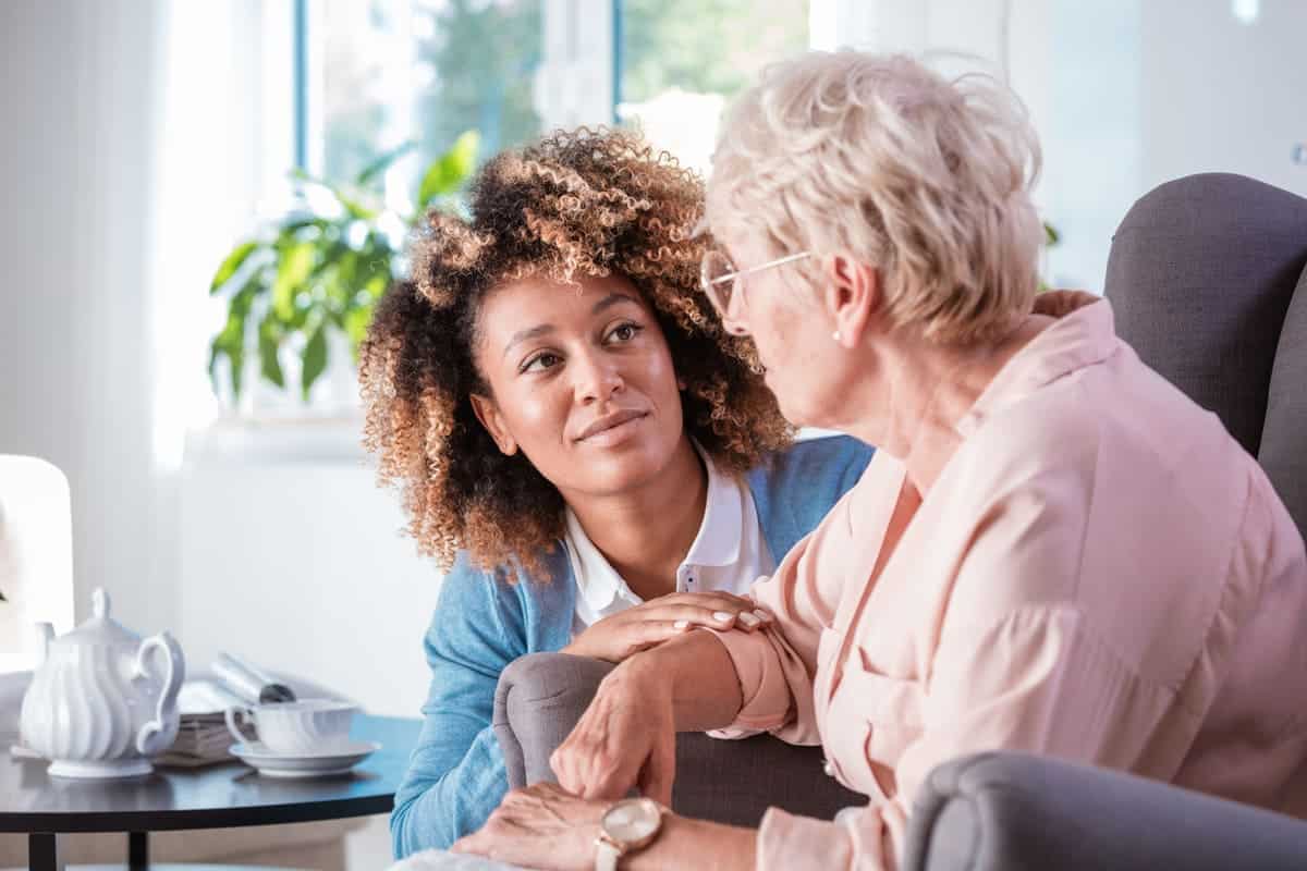 Older woman chatting with caregiver