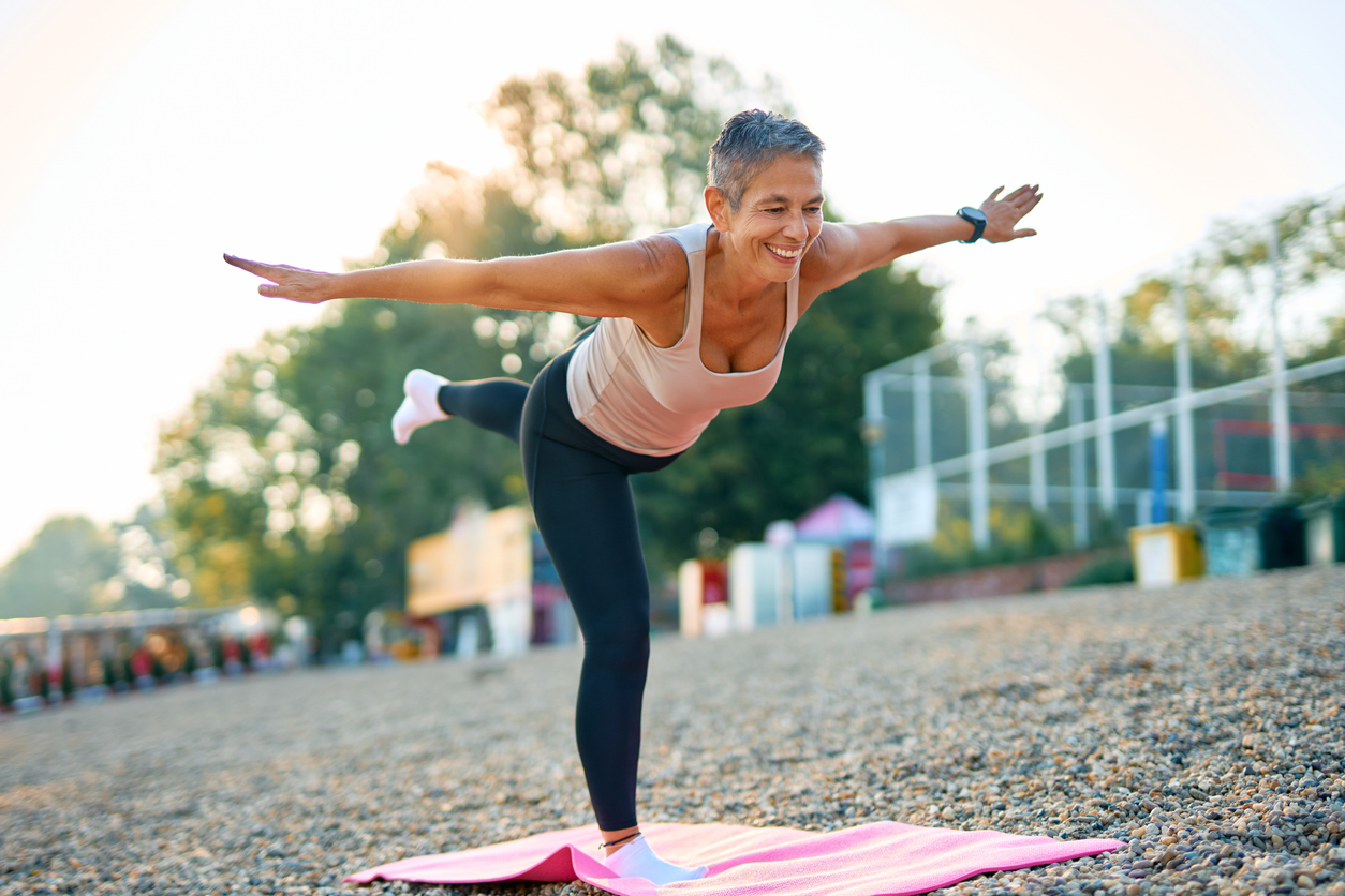 Woman balancing or doing yoga; warrior pose