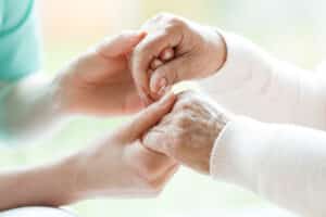 Nurse holding woman's hands