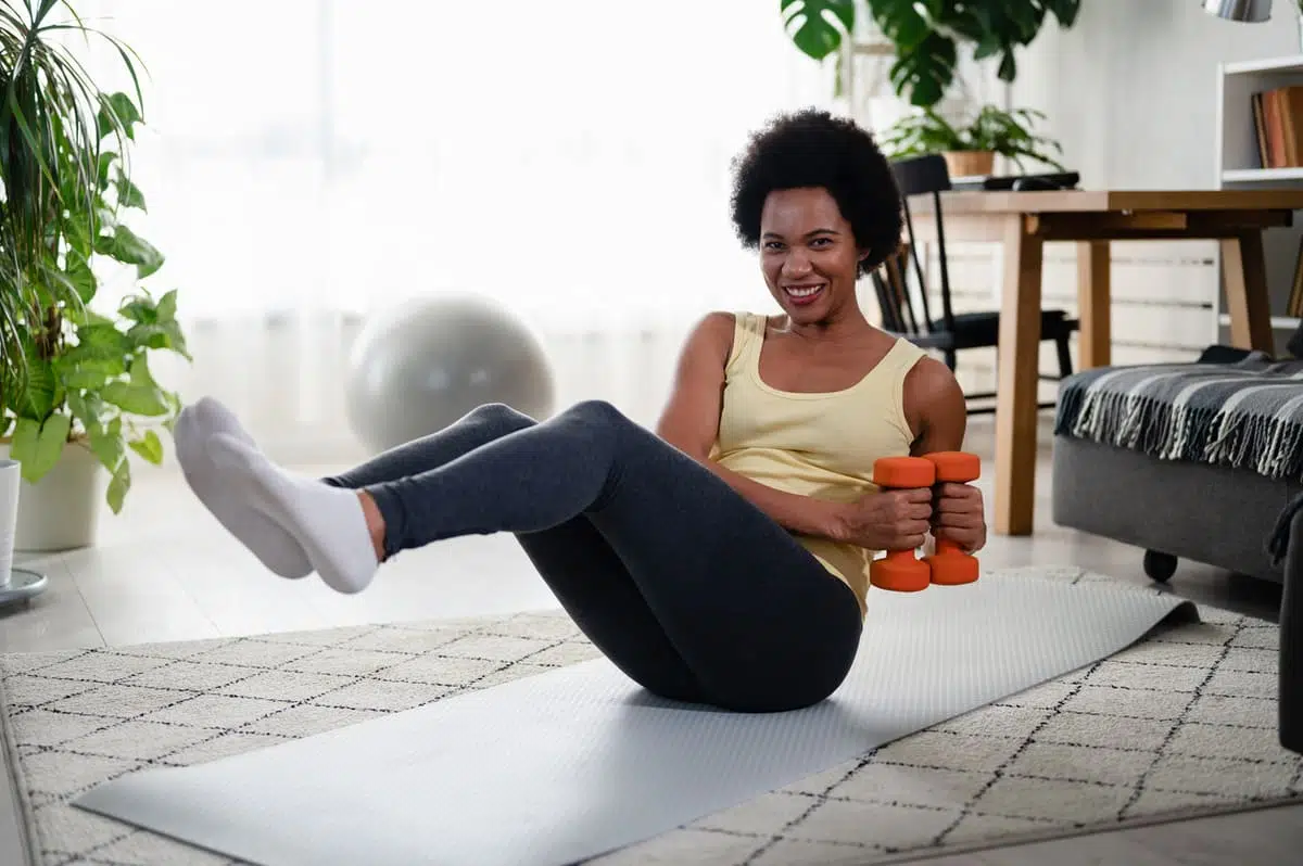 Woman doing crunches with dumbbells