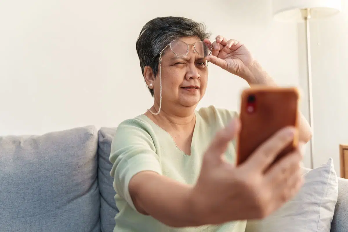 Woman squinting at phone