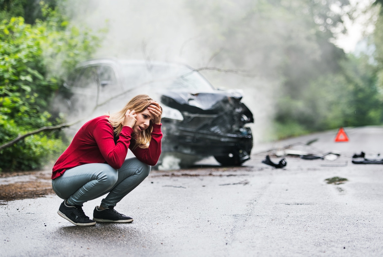 Woman after a car crash on her phone