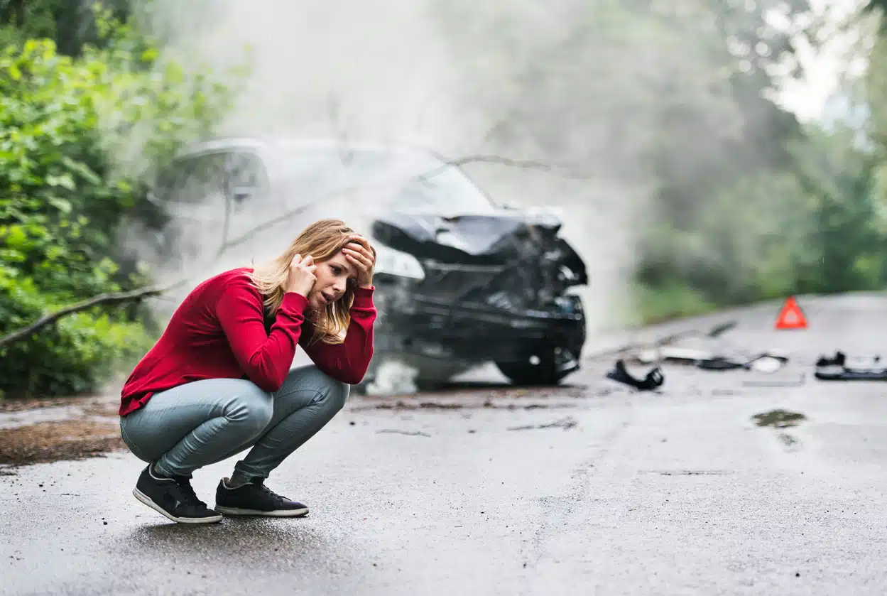 Woman after a car crash on her phone