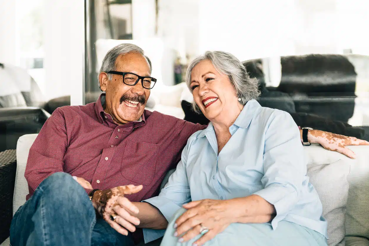 Couple laughing on the couch