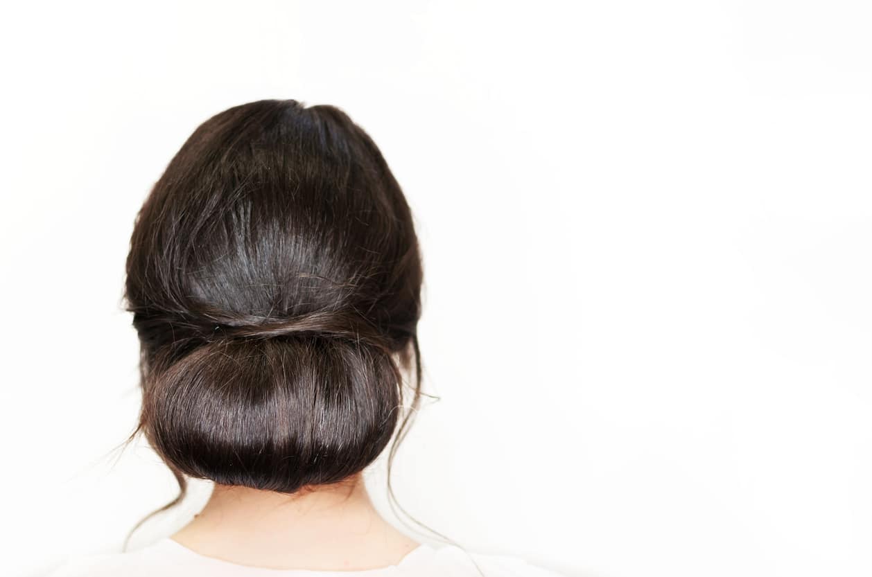 low bun hairstyle middle part