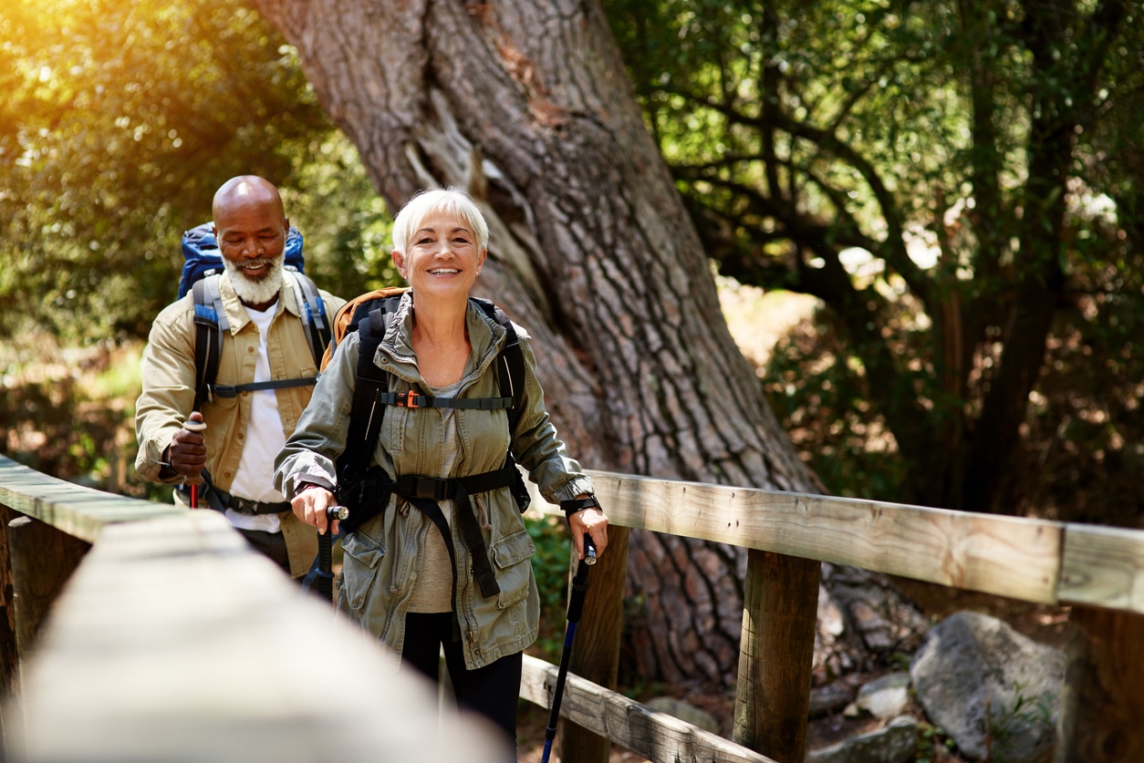 Man and woman hiking with walking sticks