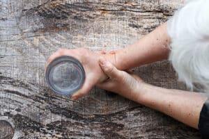 woman holding a glass of water - grip strength
