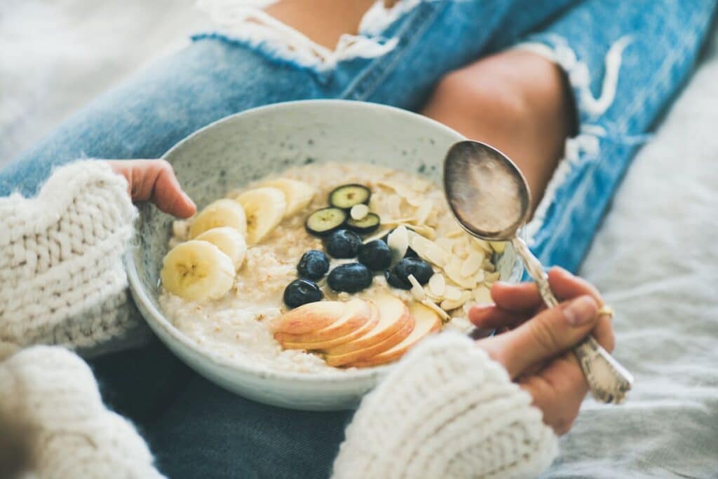 Alkaline foods and breakfast ideas woman with oatmeal