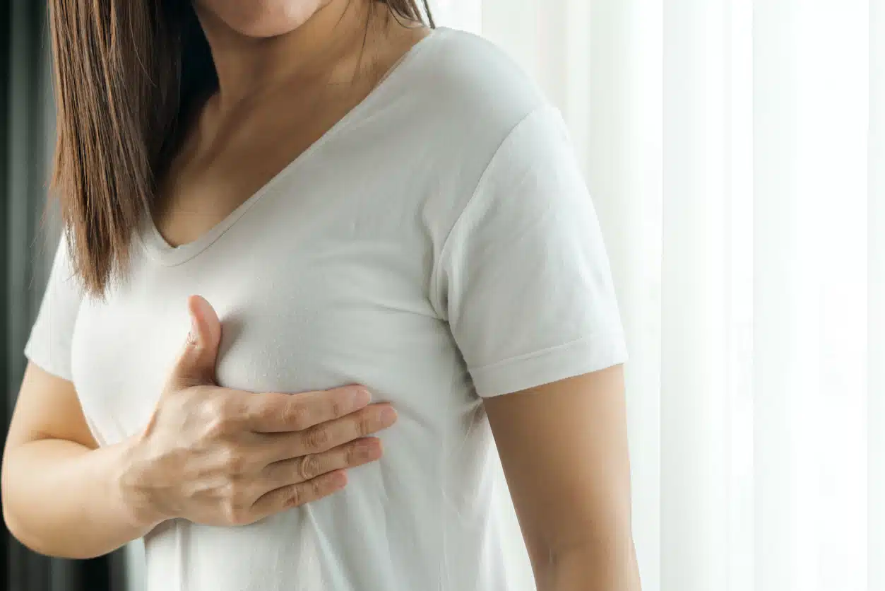 Woman performing a self breast exam