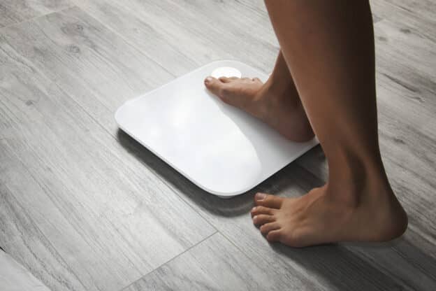 Woman stepping on the scale