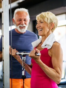 Couple working out at the gym; weight lifting