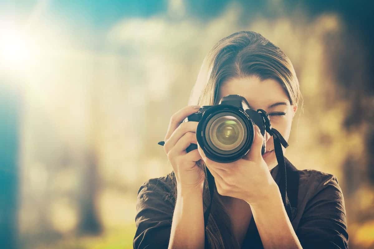 woman taking a picture for a new hobby to heal a broken heart