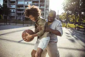 Grandfather playing basketball with grandson