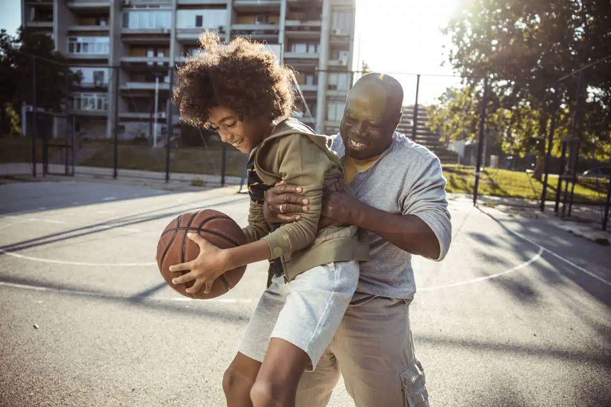 Grandfather playing basketball with grandson